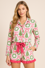Load image into Gallery viewer, Woman wearing a festive pajama set with wreath and bow pattern on a beige background