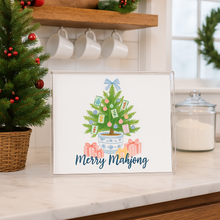 Load image into Gallery viewer, Framed artwork of a Christmas tree with presents on a kitchen counter.