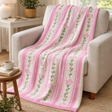 Load image into Gallery viewer, Pink floral blanket draped over a sofa in a cozy living room.
