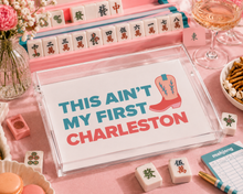 Load image into Gallery viewer, Mahjong game set with a sign reading 'This ain't my first Charleston' on a pink table.
