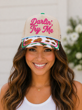 Load image into Gallery viewer, Woman wearing a beige cap with 'Darlin' Try Me' text, floral patterns, and colorful accents.
