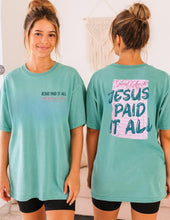 Load image into Gallery viewer, Woman wearing a teal t-shirt with 'Jesus Paid It All' text on the front and back.
