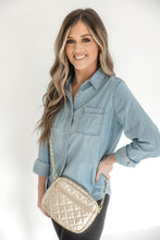 Load image into Gallery viewer, A woman wearing a denim shirt is showcasing a small quilted crossbody bag with a gold chain strap.
