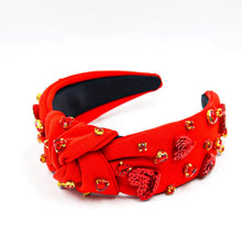 Load image into Gallery viewer, A red headband with hand-sewn heart-shaped embellishments made of rhinestone and sequins.
