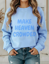 Load image into Gallery viewer, Light blue sweatshirt with 'MAKE HEAVEN CROWDED' text worn by a person.

