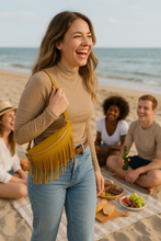 Load image into Gallery viewer, Woman laughing on a beach with friends and a picnic setup
