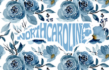 Load image into Gallery viewer, An acrylic serving tray with a blue floral pattern and the text 'NORTH CAROLINA' across the center.
