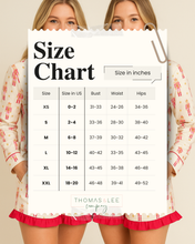 Load image into Gallery viewer, Woman holding a size chart for clothing measurements with 'Thomas &amp; Lee' branding.
