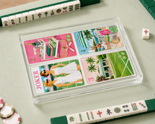 Load image into Gallery viewer, Colorful playing cards with images and text on a light green surface with tiles.

