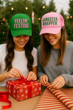 Load image into Gallery viewer, Two people wrapping gifts and wearing festive hats with humorous text.
